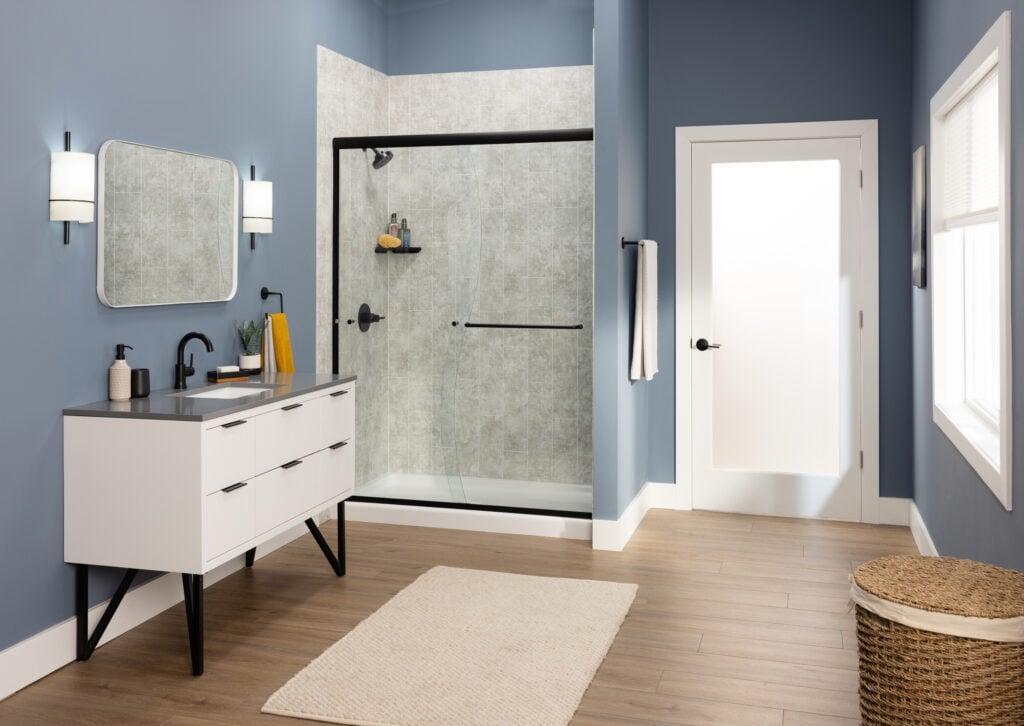 Photo of a spacious bathroom with a walk in shower that has a sliding glass door