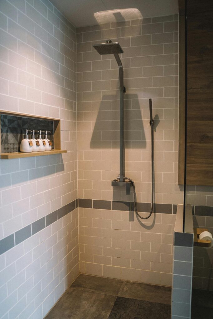 Elegant bathroom interior with a sleek shower and tile design.