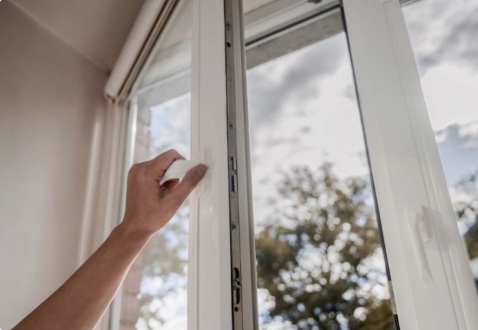 Photo of a hand opening a casement window